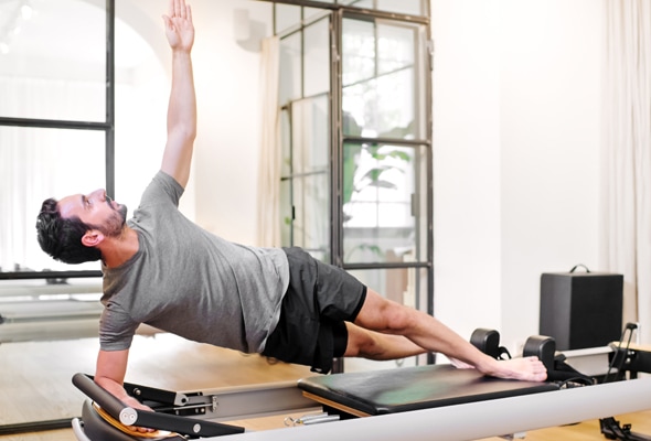 A man exercising on a pilates machine